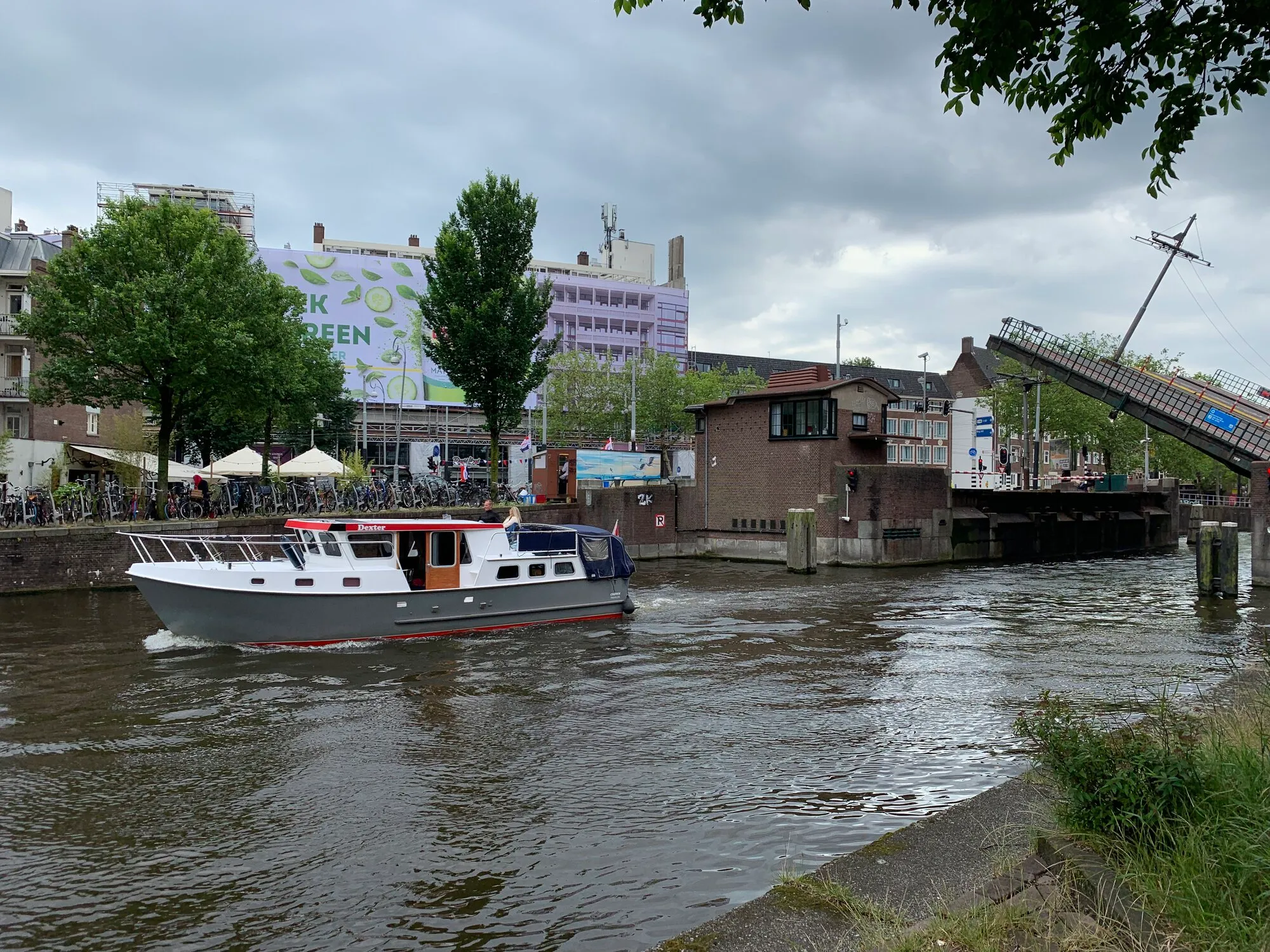 A boat just passed under an opened bridge