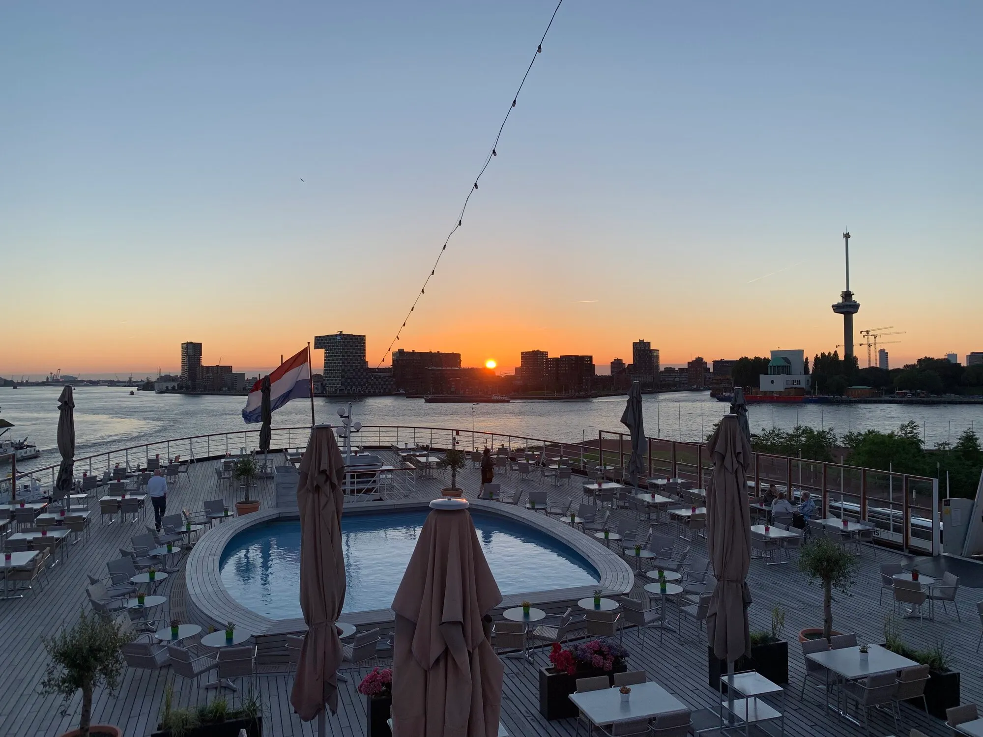 A photo of sunset in the city from the top deck of the ship