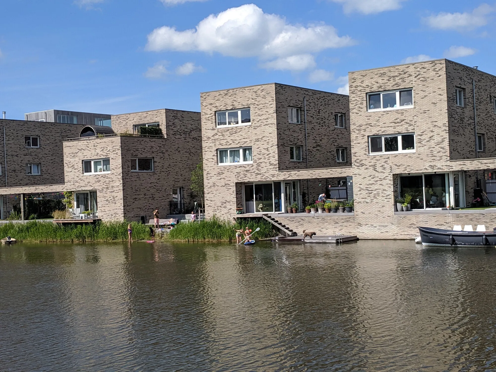 A block of buildings staying on water which backyards have ferries so you can park a boat or enjoy your time near water
