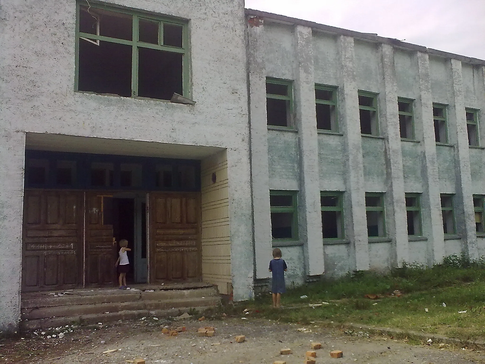 Children playing near abandoned building without windows