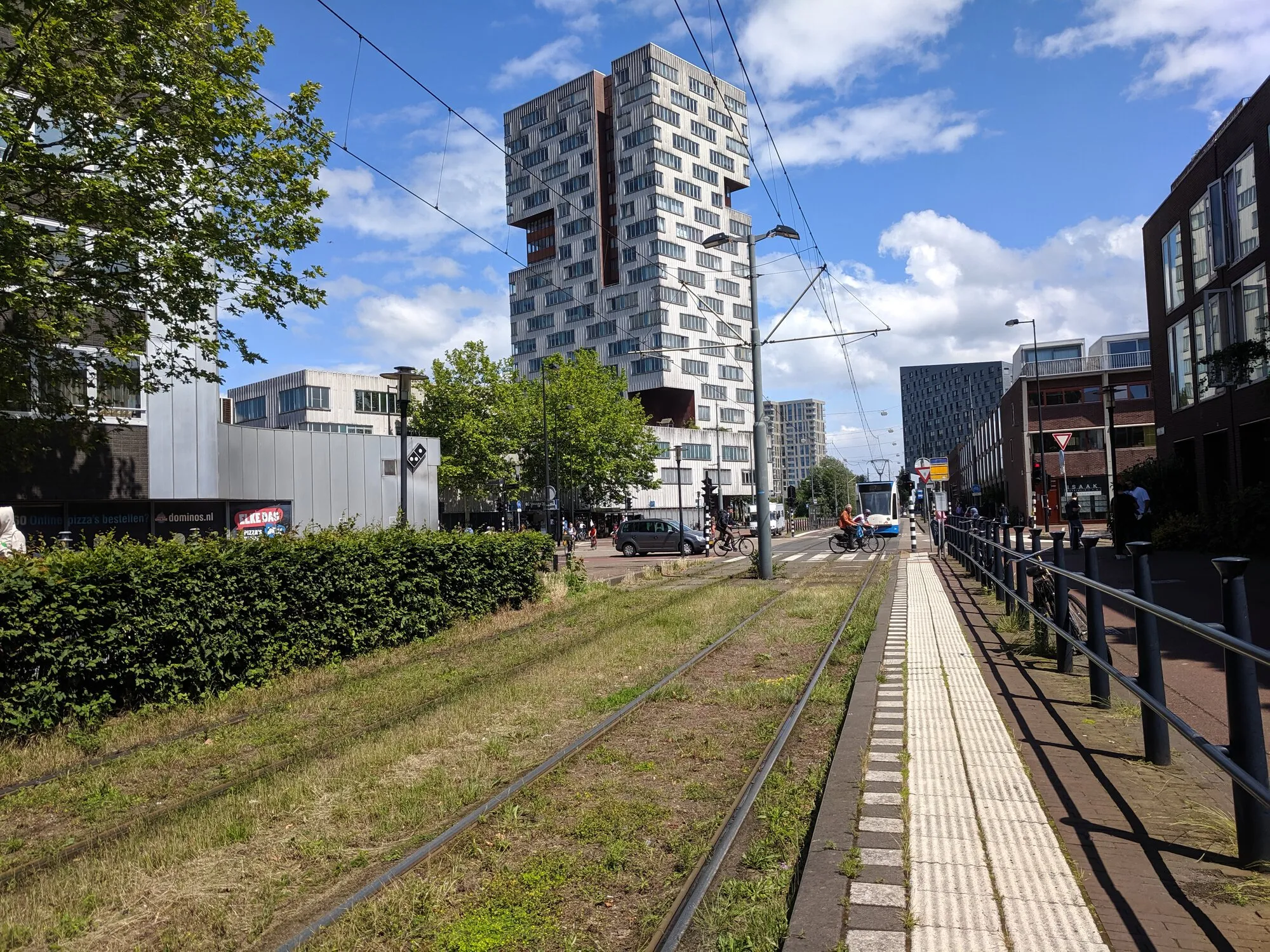 Residential building and tram line with lawn on it