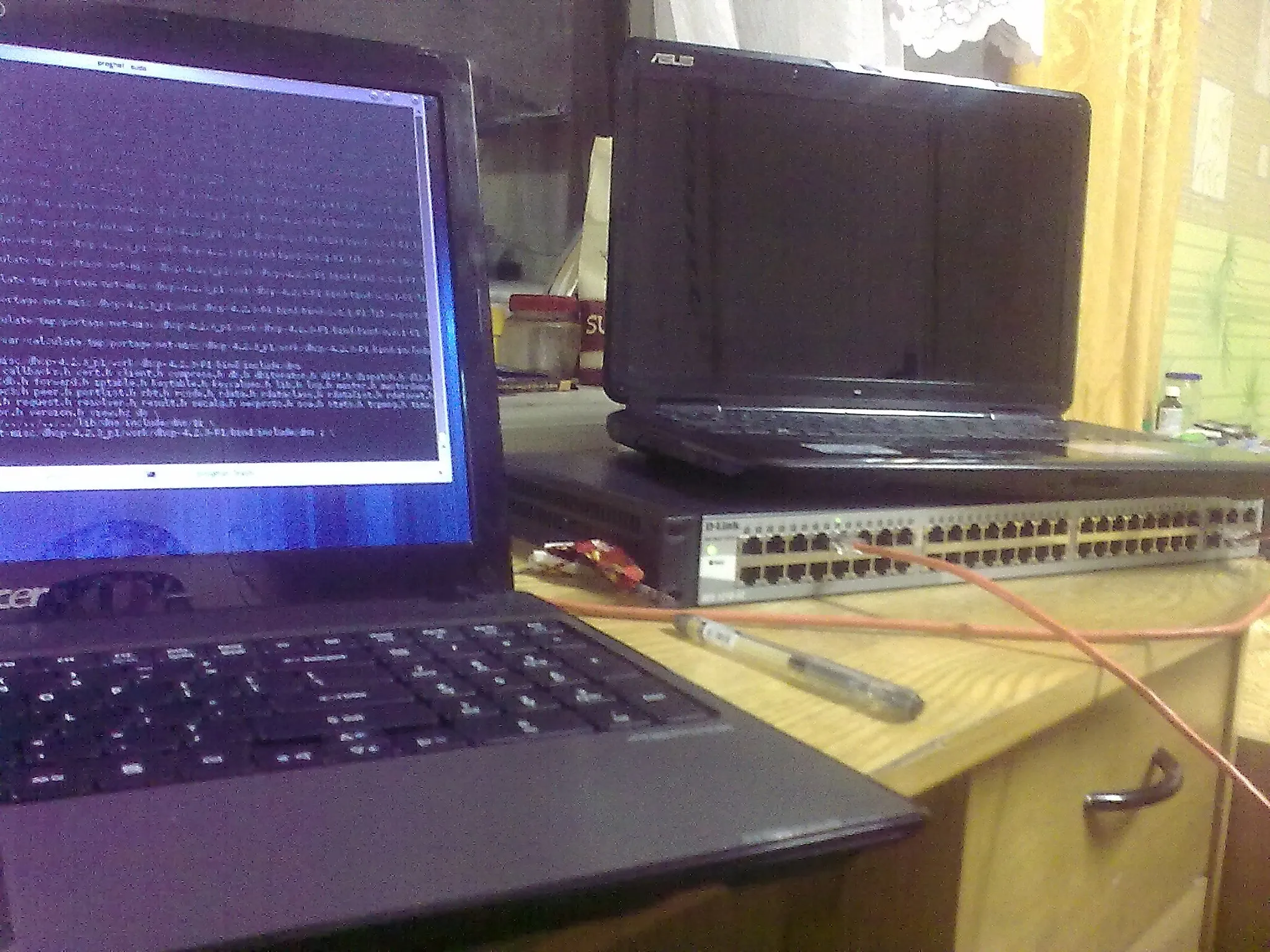 A laptop with terminal opened attached to programmable switch with many ports
